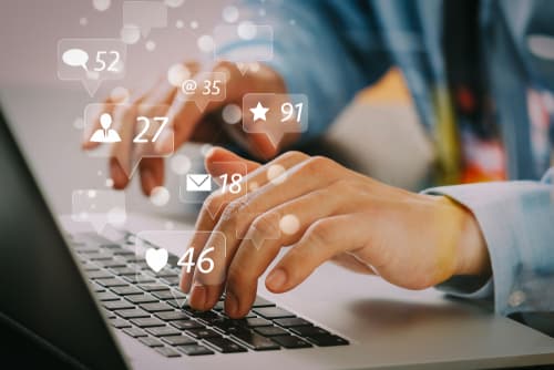 lawyer on laptop with social media icons