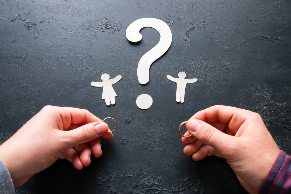 paper silhouettes of children and question mark concept divorce
